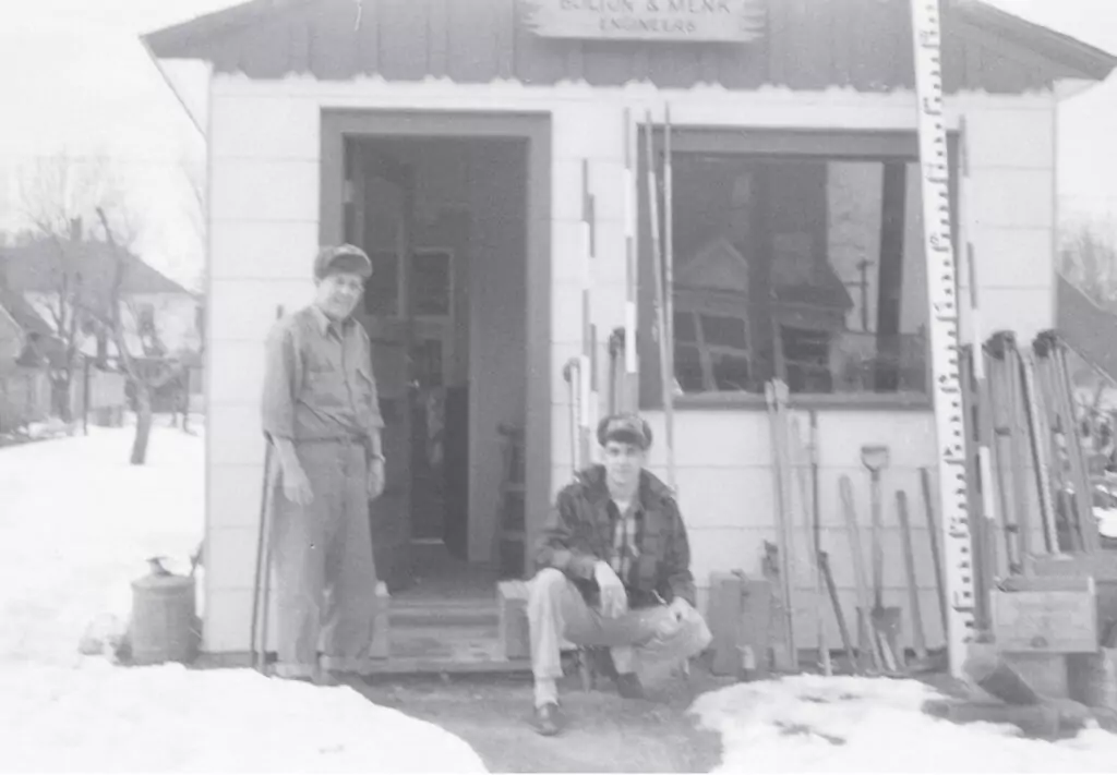 John Bolton and Martin Menk by the entrance of an early office