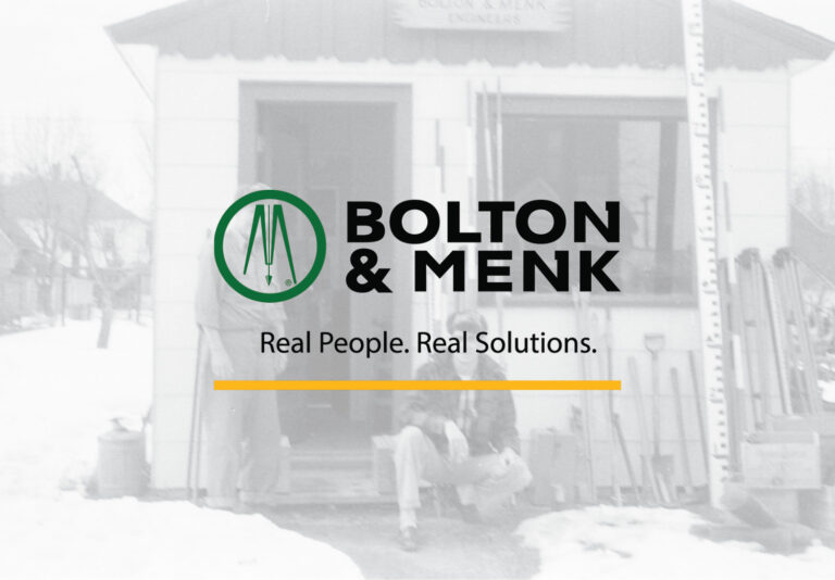 Bolton & Menk Logo Across a Snowy Historical Photo