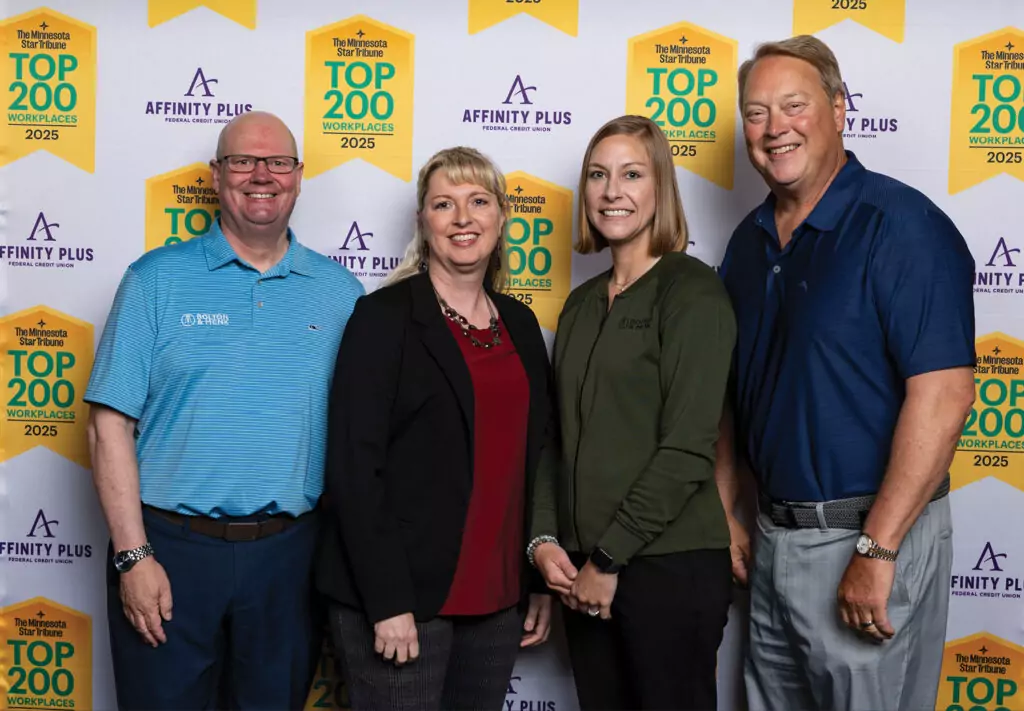 Four individuals are standing in front of a backdrop that features the logos 'Affinity Plus' and 'The Minnesota Star Tribune Top 200 Workplaces 2025.