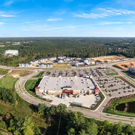 A large building surrounded roads and trees