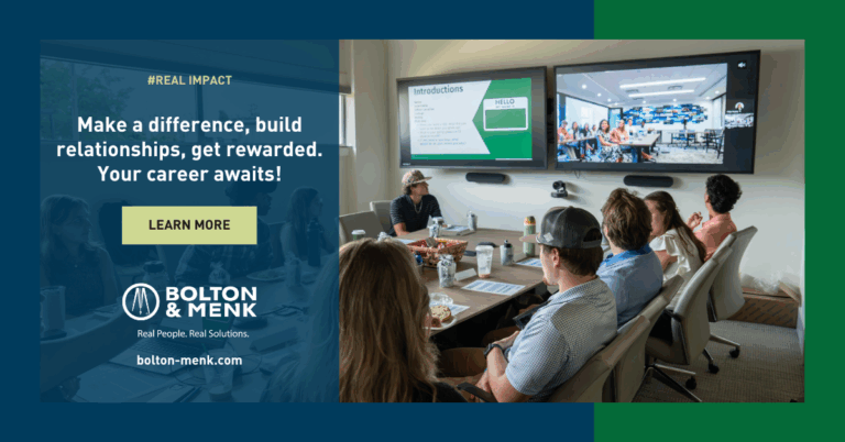 A group of people sit around a conference table watching a presentation on two large screens; text overlay reads, “Empowering communities, building relationships, get rewarded. Your career awaits!” with Bolton & Menk’s logo and website.