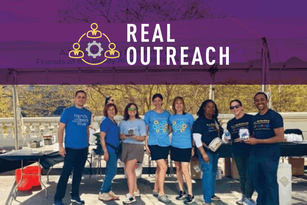 A group of eight smiling people stand together outdoors in front of a tent, holding drinks and wearing casual volunteer shirts. The image has a purple overlay with the text REAL OUTREACH and a community icon.