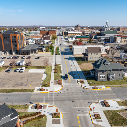 An aerial view of a downtown street and sidewalk