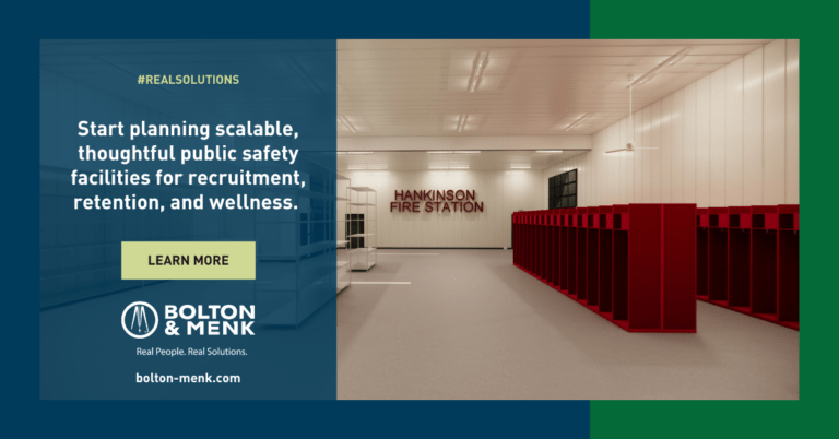 A modern fire station interior with red lockers and benches. Text reads: Start planning scalable, thoughtful public safety facilities for recruitment, retention, and wellness. Bolton & Menk. bolton-menk.com.