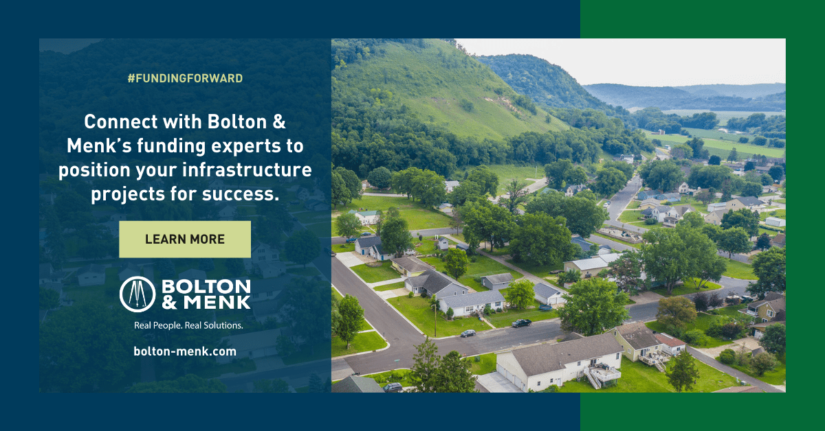 Aerial view of a small town with green hills in the background. Text reads: “Connect with Bolton & Menk’s water infrastructure funding experts to position your projects for success.” Bolton & Menk logo and website shown.