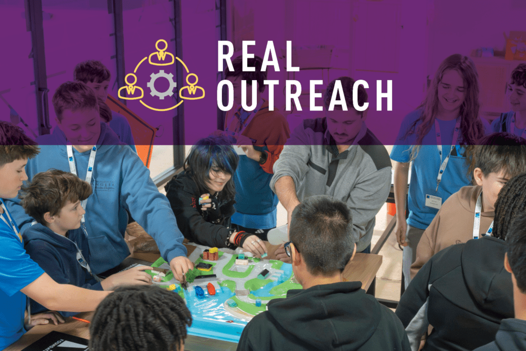 A group of students and an adult gather around a table, interacting with a colorful water-themed educational model. The top of the image displays REAL OUTREACH with a teamwork icon on a purple background.