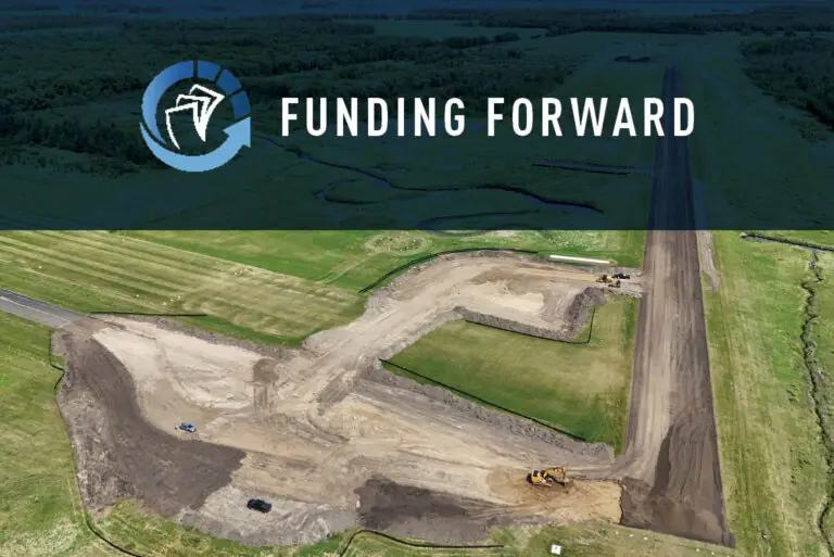 Aerial view of a construction site with earth-moving equipment on grassy land. At the top, a translucent banner reads Funding Forward with a stylized logo of a bird in a circle.